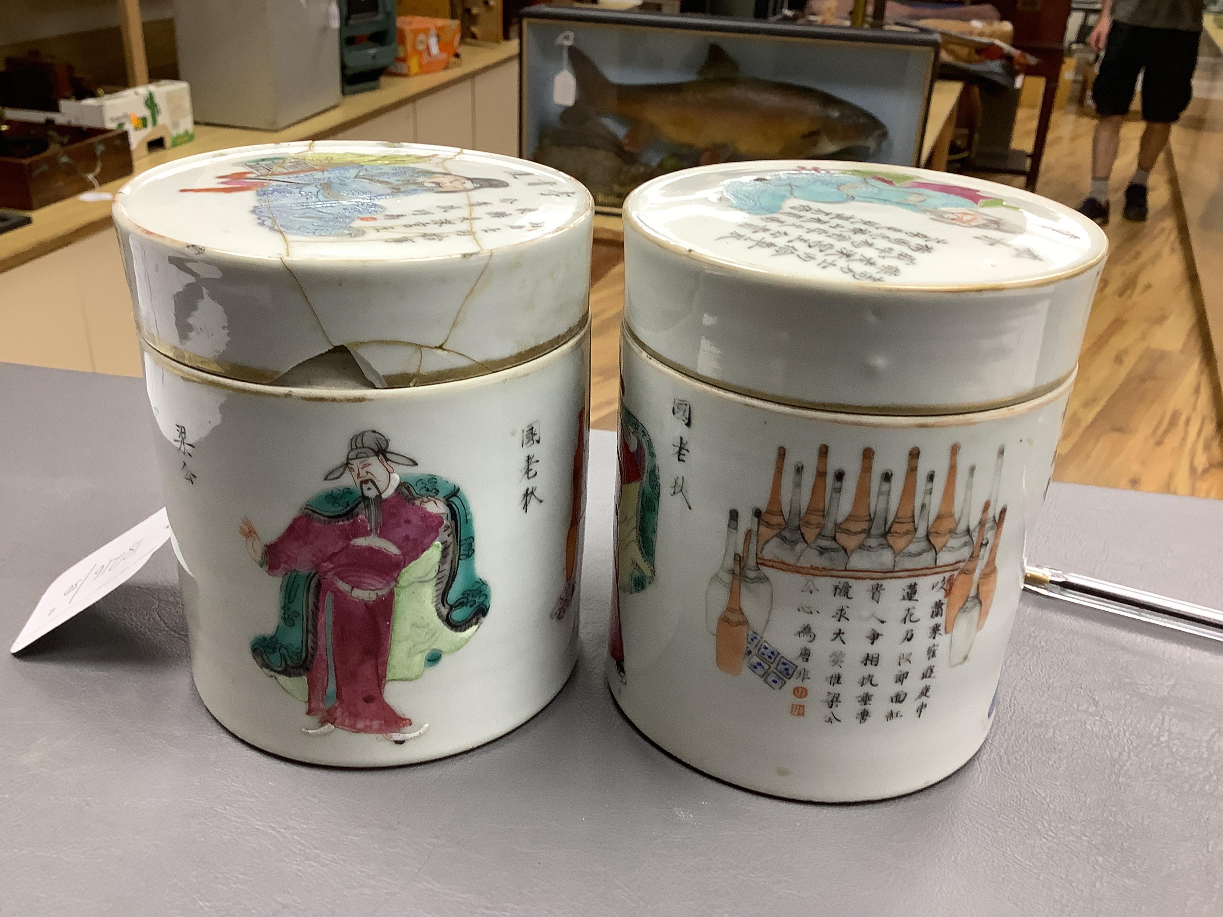 Two mid-19th century Chinese famille rose cylindrical jars and covers, enamelled with figures and calligraphy, 12cm high